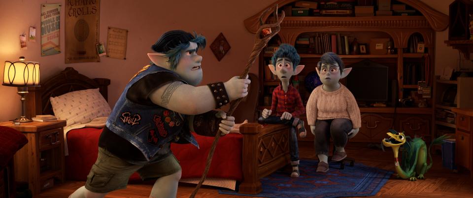 Metalhead elf Barley Lightfoot (left, voiced by Chris Pratt) tries to conjure his late father as brother Ian (Tom Holland) and mom Laurel (Julia Louis-Dreyfus) look on in Pixar's animated fantasy comedy "Onward."