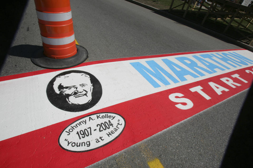 FILE - Boston Marathon patriarch Johnny Kelley's face is painted on the Boston Marathon starting line in Hopkinton, Mass., Thursday, April 14, 2005. Once a year for the last 100 years, Hopkinton becomes the center of the running world, thanks to a quirk of geography and history that made it the starting line for the world's oldest and most prestigious annual marathon. (AP Photo/Chitose Suzuki, File)