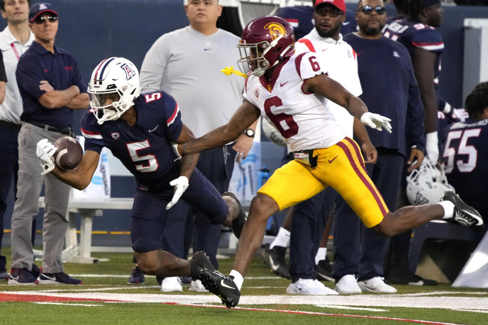 Arizona wide receiver Dorian Singer tries to make the catch in front of Southern California defensive back Mekhi Blackmon (6) in the first half during an NCAA college football game, Saturday, Oct. 29, 2022, in Tucson, Ariz. (AP Photo/Rick Scuteri)