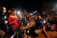 <p>Tanzil Philip, 16, a student survivor from Marjory Stoneman Douglas High School, where 17 students and faculty were killed in a mass shooting on Wednesday, speaks to a crowd of supporters and media as they arrive at Leon High School, in Tallahassee, Fla., Tuesday, Feb. 20, 2018. The students arrived in the state’s capital to talk to legislators and rally for gun control reform. (Photo: Gerald Herbert/AP) </p>