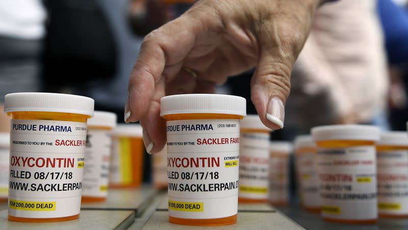 In this Aug. 17, 2018, file photo, family and friends who have lost loved ones to OxyContin and opioid overdoses leave pill bottles in protest outside the headquarters of Purdue Pharma, which is owned by the Sackler family, in Stamford, Conn. The U.S. Supreme Court on Thursday, Aug. 11., 2023, put a bankruptcy deal for Purdue Pharma on hold, pending a review.