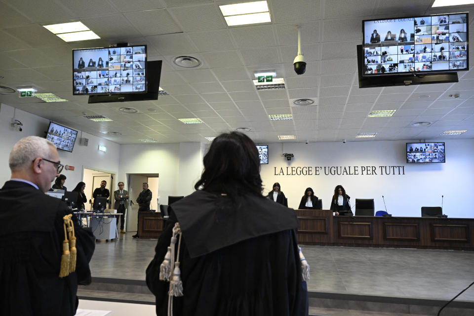 Facing the camera, President of the court Judge Brigida Cavasino, center, flanked by judges Claudia Caputo, left, and Germana Radice reads the sentence of a maxi-trial of hundreds of people accused of membership in Italy's 'ndrangheta organized crime syndicate, one of the world's most powerful, extensive and wealthy drug-trafficking groups, in Lamezia Terme, southern Italy, Monday, Nov. 20, 2023. The trial started almost three years ago in the southern Calabria region, where the mob organization was originally based. (AP Photo/Valeria Ferraro)