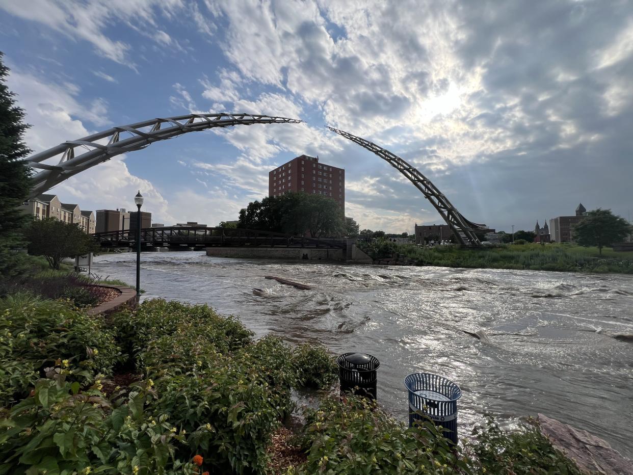 The Big Sioux River is seen rushing Friday, June 21, 2024, through downtown Sioux Falls at high levels after torrential rain overnight.