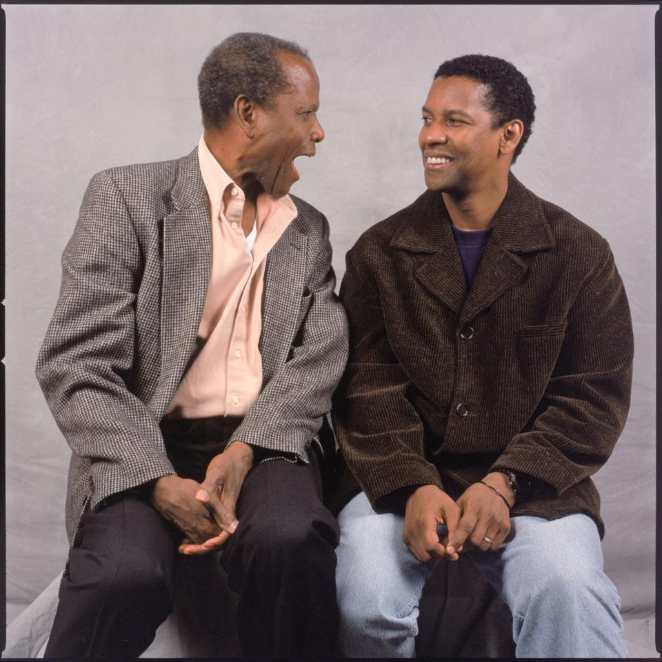 Denzel Washington and Sidney Poitier pose for photos after an interview with USA TODAY in 2000.