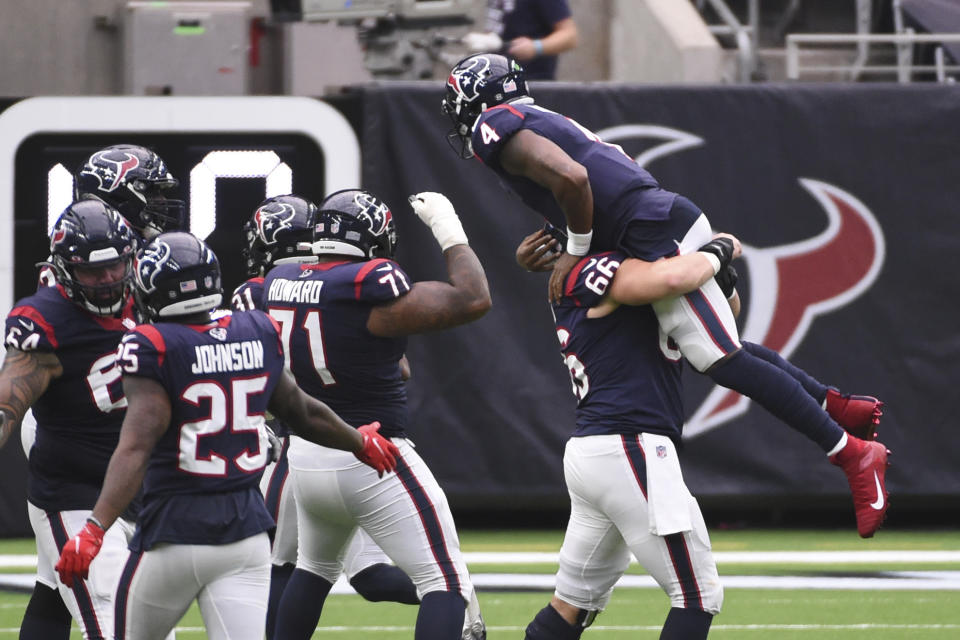 Houston Texans quarterback Deshaun Watson (4) is lifted in the air by teammate Nick Martin (66) as the team celebrates a touchdown against the Jacksonville Jaguars the second half of an NFL football game Sunday, Oct. 11, 2020, in Houston. (AP Photo/Eric Christian Smith)