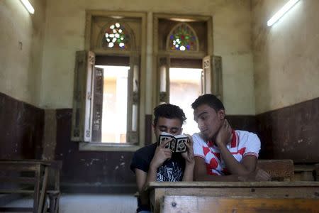 Students revise for a Koran verbal recital exam in one of the Al-Azhar institutes in Cairo, Egypt, May 20, 2015. REUTERS/Asmaa Waguih