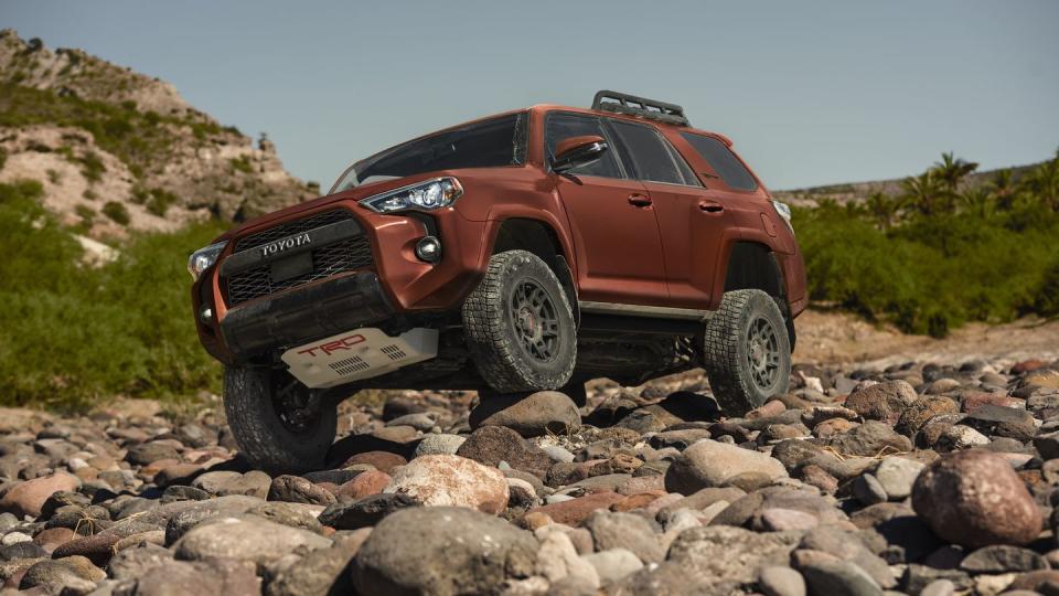 toyota 4runner suv driving over rocks