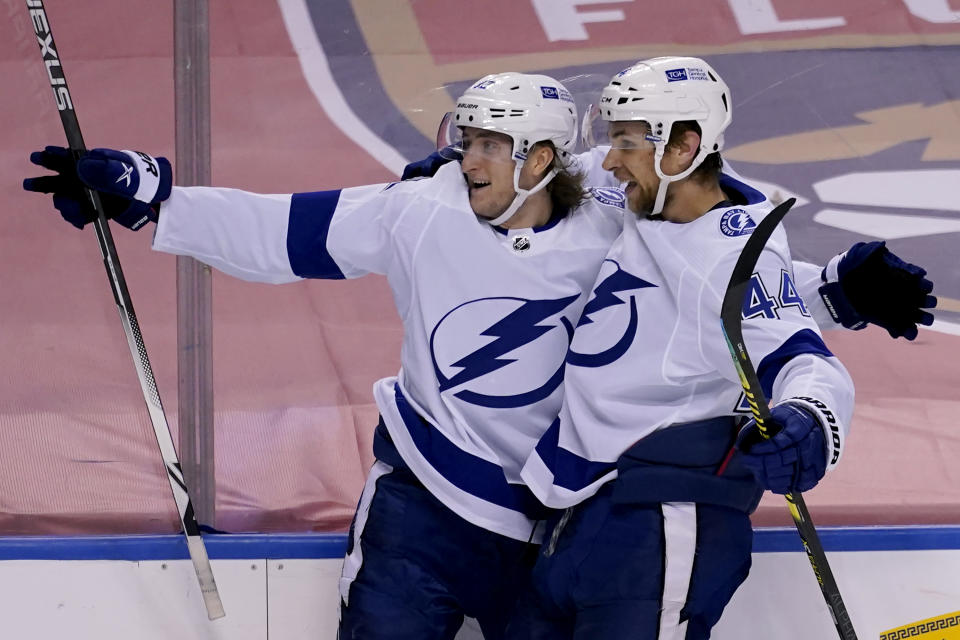 Tampa Bay Lightning right wing Alexander Volkov, left, celebrates with defenseman Jan Rutta (44) after scoring a goal against the Florida Panthers during the third period of an NHL hockey game, Saturday, Feb. 13, 2021, in Sunrise, Fla. (AP Photo/Lynne Sladky)