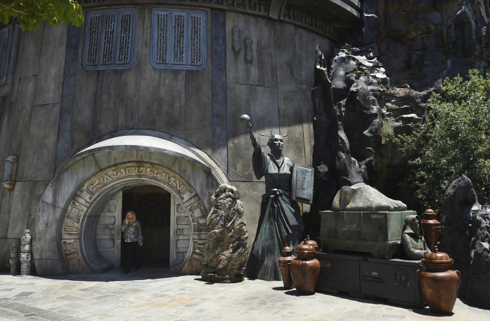 A visitor exits the Dok-Ondar's Den of Antiquities store during the Star Wars: Galaxy's Edge Media Preview at Disneyland Park, Wednesday, May 29, 2019, in Anaheim, Calif. (Photo by Chris Pizzello/Invision/AP)
