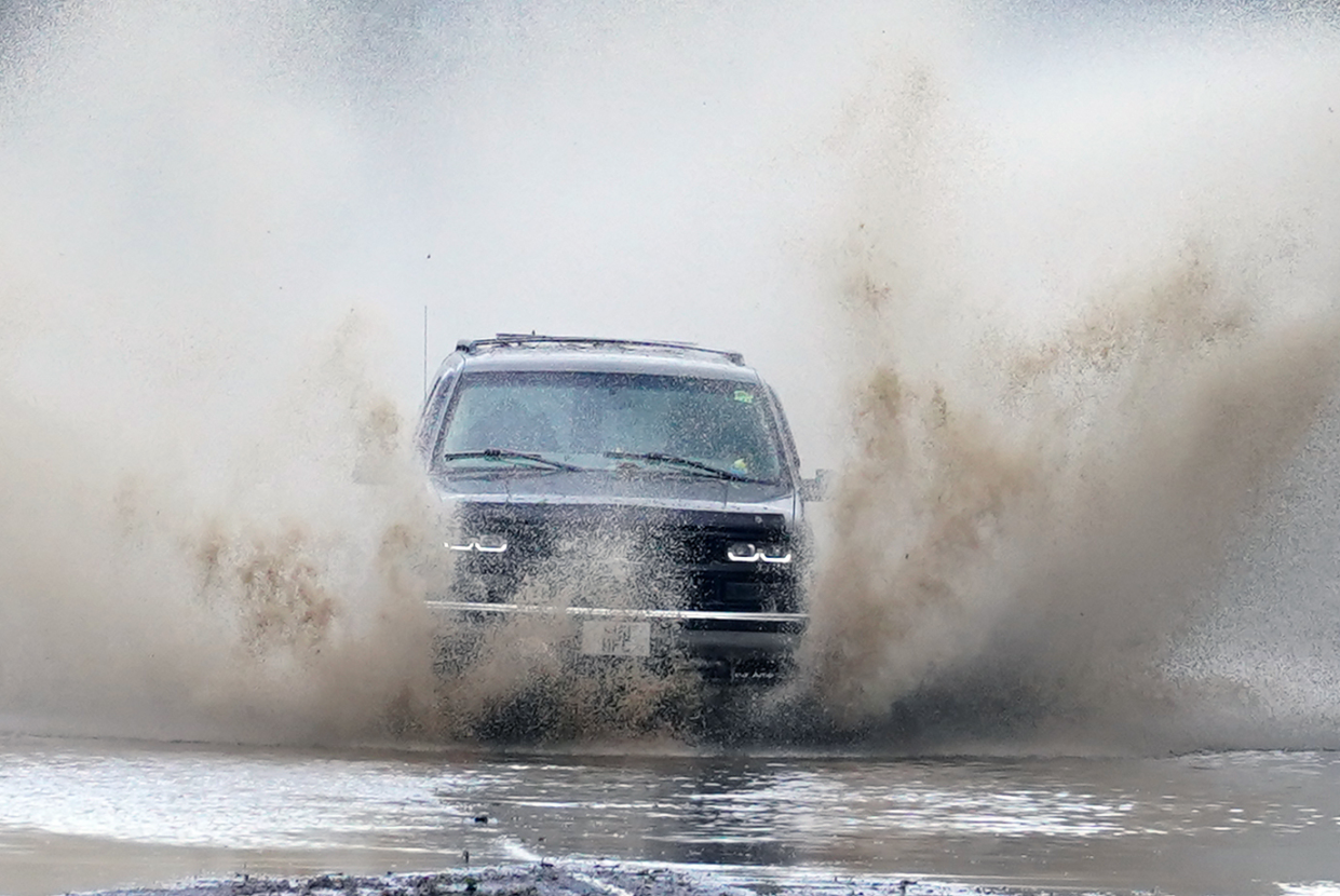 A car drives through flood water near Folkestone, Kent (PA)