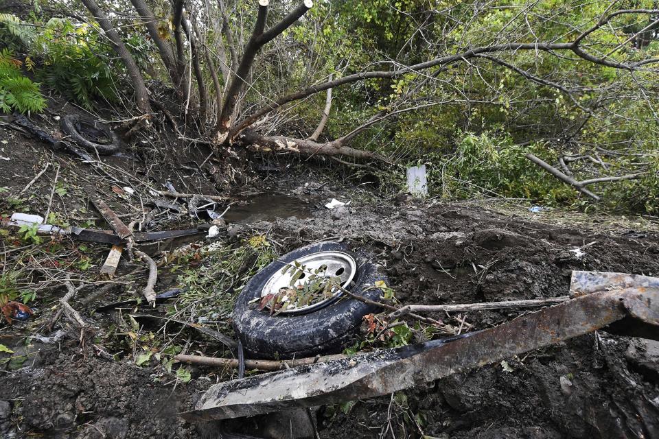 FILE - Debris scatters at the site of a fatal limousine crash that killed 20 people, in Schoharie, N.Y. , Oct. 7, 2018. On Wednesday, Aug. 31, 2022, a judge rejected a plea agreement that would have meant no prison time for the operator of the limousine company involved the crash, drawing applause and tears from victims' relatives who packed the court. (AP Photo/Hans Pennink, File)