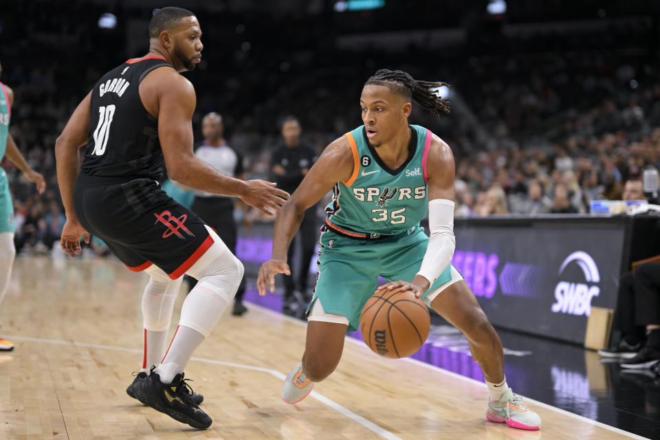 San Antonio Spurs' Romeo Langford (35) drives against Houston Rockets' Eric Gordon during the second half of an NBA basketball game Thursday, Dec. 8, 2022, in San Antonio. (AP Photo/Darren Abate)