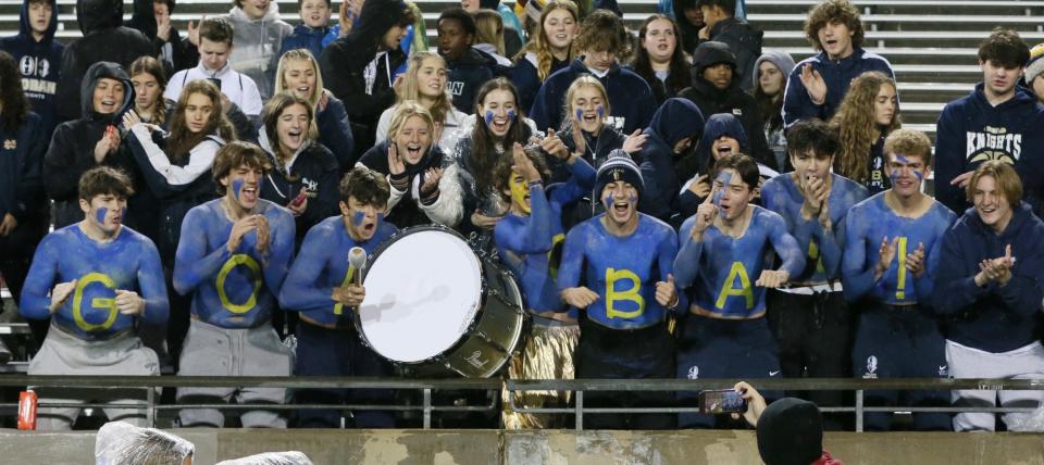 Hoban High fans cheer before the start of the Division II regional semifinal against St. Vincent-St Mary High at the University of Akron.