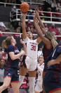 Stanford guard Haley Jones (30) shoots against Gonzaga's Brynna Maxwell, left, and Yvonne Ejim, right, during the first half of an NCAA college basketball game in Stanford, Calif., Sunday, Dec. 4, 2022. (AP Photo/Tony Avelar)