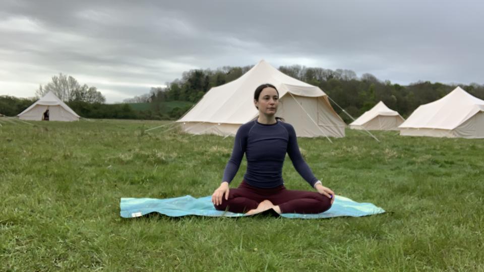 Woman doing yoga at glampsite