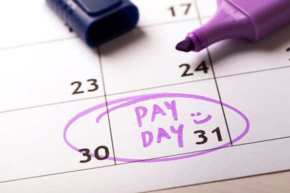 Word payday written on calendar in purple highlighter and circled.