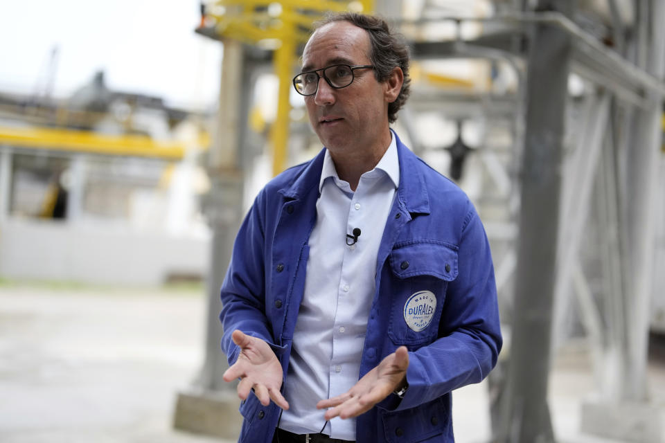 Duralex CEO, Jose Luis Llacuna, talks to The Associated Press outside the factory of the French glassmaker Duralex, in La Chapelle Saint-Mesmin, central France, Wednesday, Sept. 7, 2022. Iconic French tableware brand Duralex is joining a growing array of European firms that are reducing and halting production because of soaring energy costs. (AP Photo/Thibault Camus)