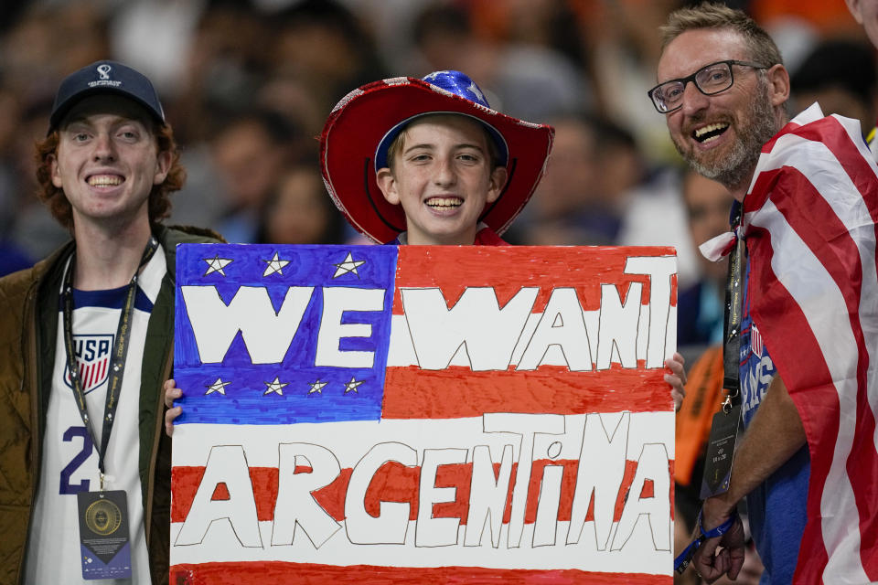 A U.S. fan holds a placard before the World Cup round of 16 soccer match between the Netherlands and the United States, at the Khalifa International Stadium in Doha, Qatar, Saturday, Dec. 3, 2022. (AP Photo/Ebrahim Noroozi)