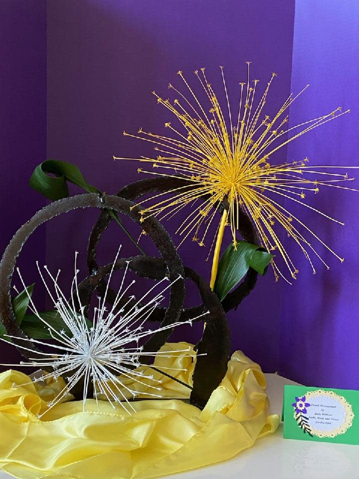 As a tribute to the eclipse, Judy Widman used sprayed Schubertii allium heads to convey the coming moon over the sun event, displaying it locally.