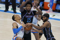 Sacramento Kings forward Maurice Harkless, right, knocks the ball away from Oklahoma City Thunder forward Darius Bazley (7) in front of teammate center Damian Jones (15) in the first half of an NBA basketball game Tuesday, May 4, 2021, in Oklahoma City. (AP Photo/Sue Ogrocki)