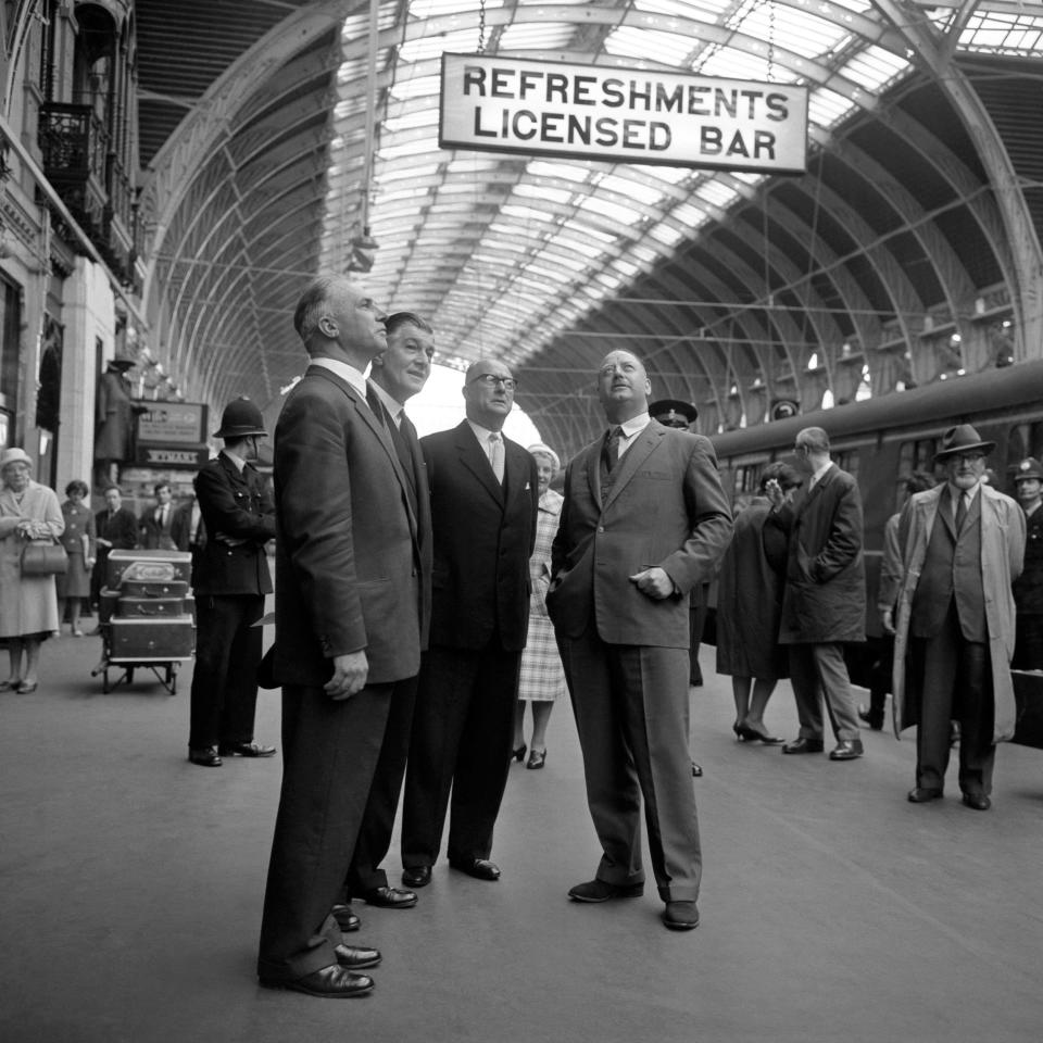 Dr Richard Beeching (right) Chairman of the British Railways Board and Mr S. E. Raymond (from left), Mr G.A.V Phillips and Mr P. Peyman examining the newly painted arch of Paddington Station's Brunel roofin 1963