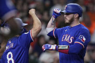 Texas Rangers' Jonah Heim, right, celebrates with Josh Smith (8) after hitting a three-run home run during the third inning of the team's baseball game against the Houston Astros on Friday, April 12, 2024, in Houston. (AP Photo/Kevin M. Cox)