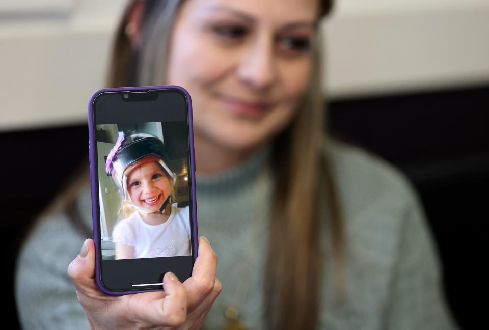 Catrina Nelson shows a picture of her daughter Charlee Nelson on her phone at Avenue Bakery in American Fork on Monday, March 20, 2023. Charlee’s Law was named after her, allowing CBD oil for epilepsy in Utah. Charlee, who had Batten disease and suffered frequent seizures, died just days after the law was passed and never got to try the oil herself. | Kristin Murphy, Deseret News