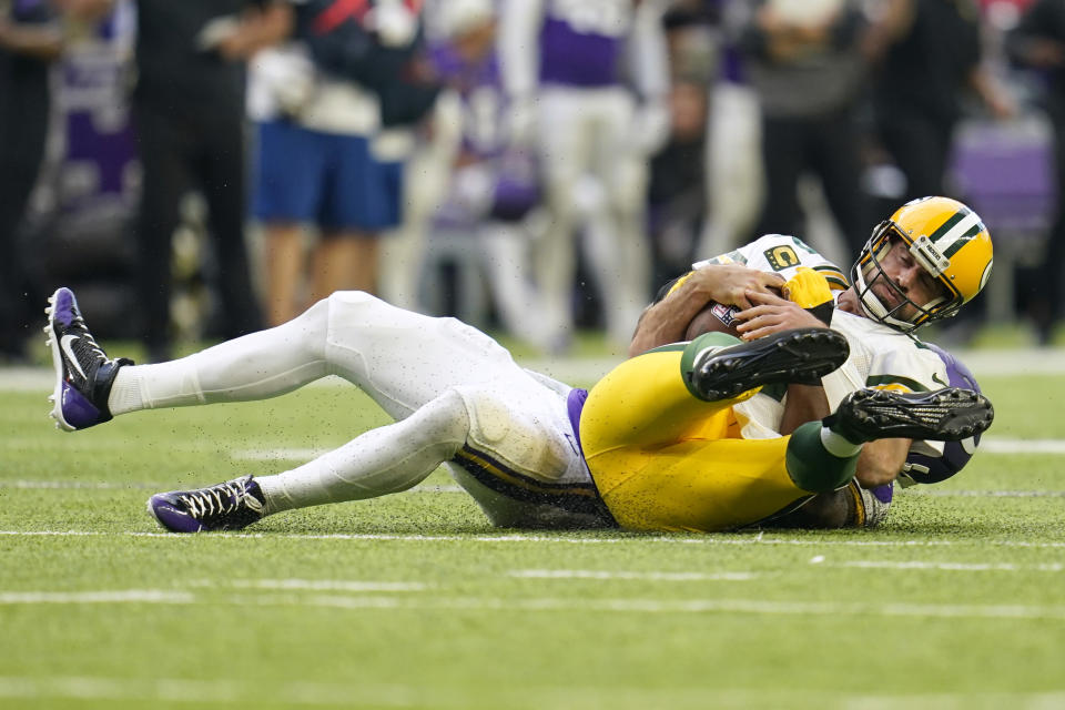 Green Bay Packers quarterback Aaron Rodgers is sacked by Minnesota Vikings linebacker Danielle Hunter, rear, during the second half of an NFL football game, Sunday, Sept. 11, 2022, in Minneapolis. (AP Photo/Abbie Parr)