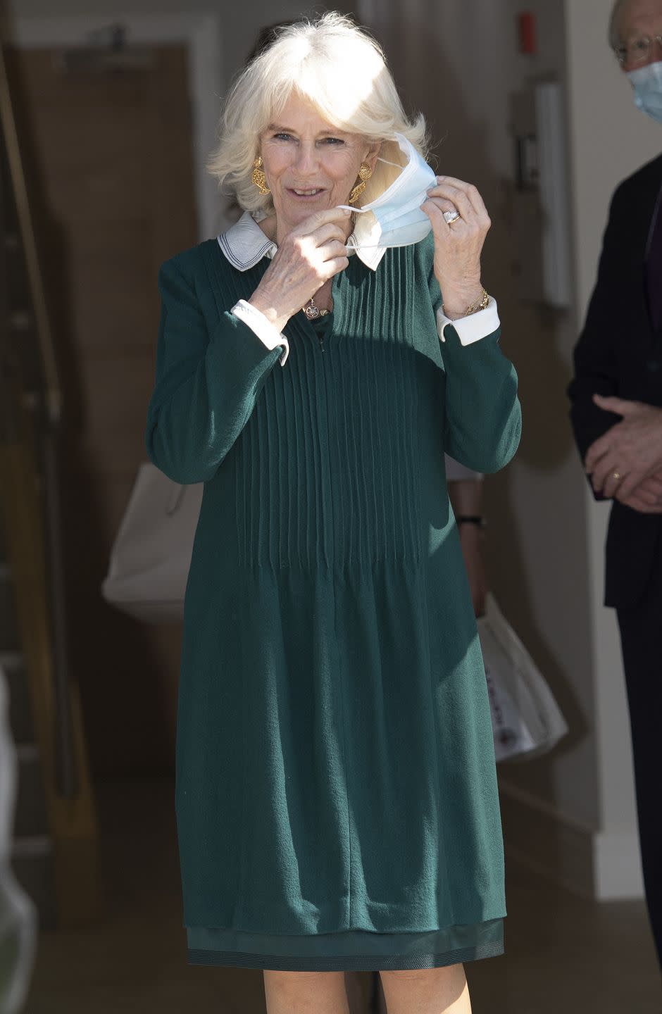 <p>Camilla wore a collared green and white dress and gold statement earrings while visiting frontline workers at a pharmacy in Sussex. <br></p>