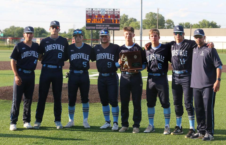 Louisville poses for a photo with the runner-up trophy after being defeated in their DII regional final against Chardon at Thurman Munson Memorial Stadium on Friday, June 3, 2022. From left are Anthony Warner, 4, Derek Lizer, 8, Caleb Miller, 5, Connor Adelman, 9, Walker Kandel, with trophy, Zack Seaman, 6, JT Popick, 11, and head coach Brian Warner. 