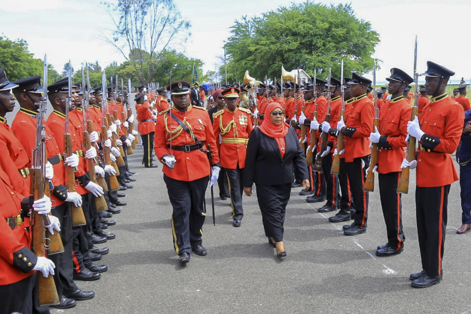 Tanzania's new president Samia Suluhu Hassan, center-right, inspects the guard of honor after being sworn in at a ceremony at State House in Dar es Salaam, Tanzania Friday, March 19, 2021. Samia Suluhu Hassan made history Friday when she was sworn in as Tanzania's first female president, following the death of her predecessor John Magufuli. (AP Photo)