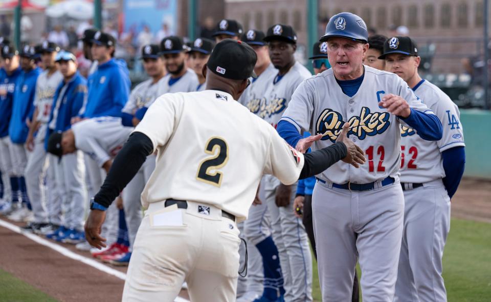 Visalia Rawhide Manager Dee Garner, left, and Quakes Manager John Shoemaker shake hands Tuesday, April 11, 2023 before the game.