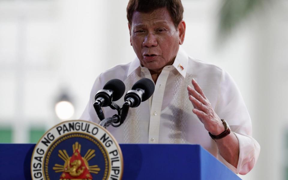 In this June 12, 2021, photo, Philippine President Rodrigo Duterte speaks during ceremonies to mark the 123rd anniversary of the Philippine independence at the Provincial Capitol of Bulacan province, Philippines. Duterte will never cooperate with a possible International Criminal Court investigation into the thousands of killings under his anti-drugs crackdown, his spokesman said Tuesday, June 15, 2021, - AP