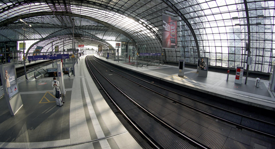 FILE - A person stands on an empty station platform at the main station in Berlin, Germany, Thursday, Sept. 2, 2021. Mediators on Wednesday presented their proposal to end a long-running pay dispute between Germany's main national railway operator and a major union, a two-year settlement that would head off damaging all-out strikes. (AP Photo/Michael Sohn, File)