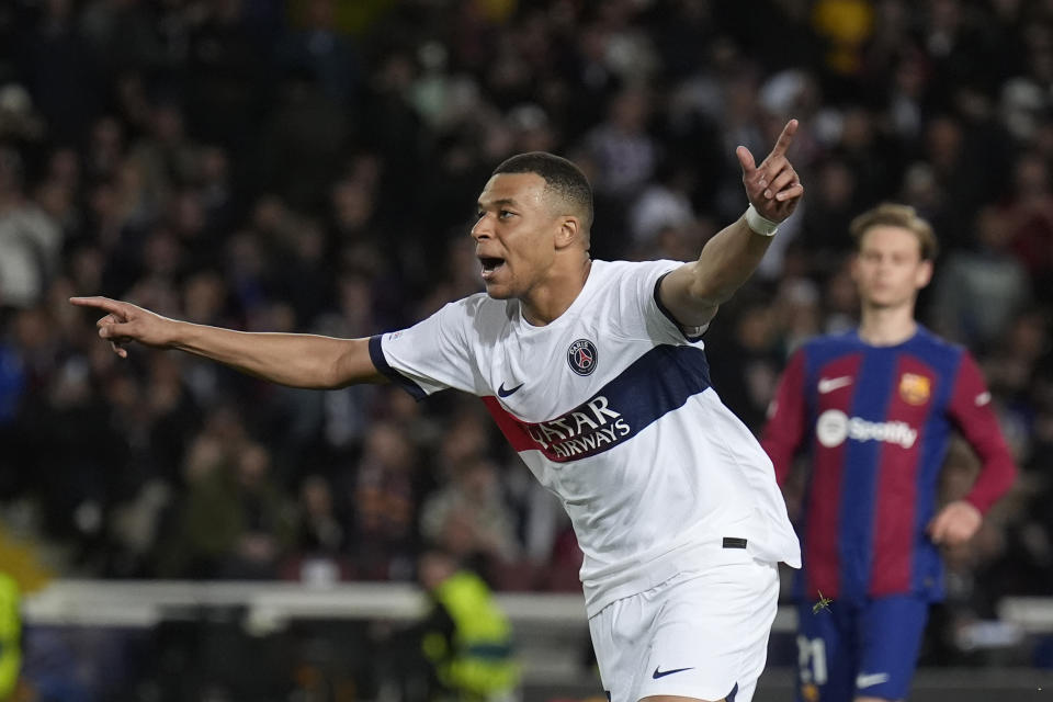 PSG's Kylian Mbappe celebrates after scoring his side's third goal during the Champions League quarterfinal second leg soccer match between Barcelona and Paris Saint-Germain at the Olimpic Lluis Companys stadium in Barcelona, Spain, Tuesday, April 16, 2024. (AP Photo/Emilio Morenatti)