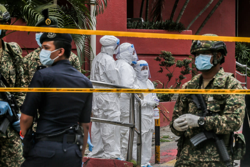 Health workers are seen at Menara City One during the enhanced movement control order (EMCO) in Kuala Lumpur April 5, 2020. — Picture by Firdaus Latif