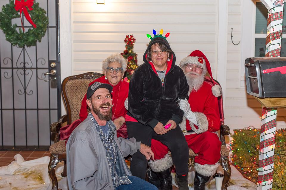 Royce and Kimberly Kendrick pose with Mr. and Mr. Santa Claus (Santa Ray).  Another Chance House hosts Home for Christmas event with cookie decorating, a choir, storytelling and Mr. and Mrs. Claus along with food trucks around the properties.