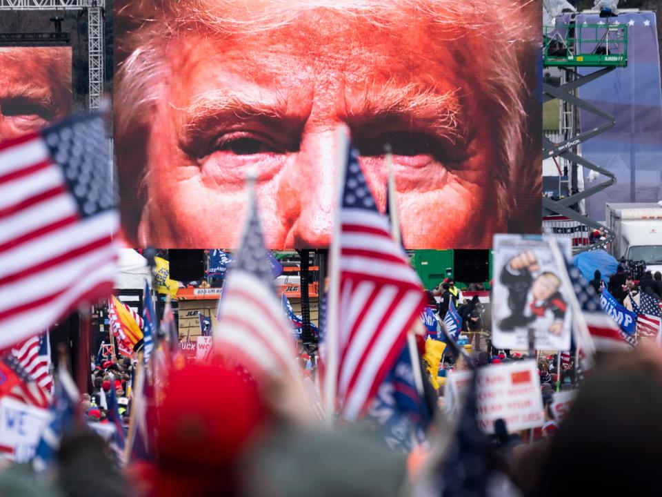 An image of President Donald Trump appears on video screens before his speech to supporters from the Ellipse at the White House