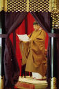 FILE - In this Nov. 12, 1990, file photo, then Japan's Emperor Akihito reads an address as he formally ascends to the Chrysanthemum Throne at the imperial palace in Tokyo. Japan is abuzz ahead of a ceremony Tuesday, Oct. 22, 2019, marking Emperor Naruhito’s ascension to the Chrysanthemum Throne. It is one of several formal ceremonies for Naruhito, 59, who has been a full-fledged emperor since succeeding in May after the abdication of his father, Akihito. (AP Photo/Koji Sasahara, File)