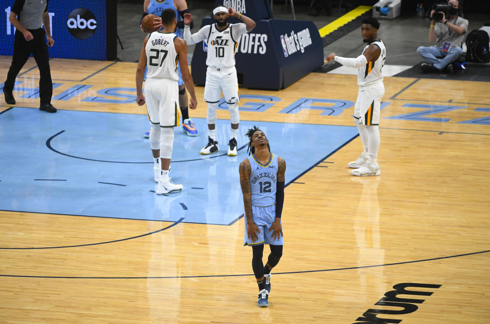 Memphis Grizzlies guard Ja Morant (12) reacts to a missed opportunity during the final minutes of Game 3 of an NBA basketball first-round playoff series against the Utah Jazz, Saturday, May 29, 2021, in Memphis, Tenn. Utah won 121-111.(AP Photo/John Amis)