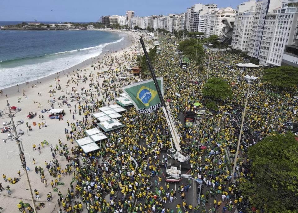 FILE - In this Sept. 7, 2021 file photo, supporters of Brazilian President Jair Bolsonaro gather along Copacabana Beach on Independence Day in Rio de Janeiro, Brazil. People used to watch the sunset from the beach before 2019 when Brazilian President Jair Bolsonaro ended the practice of changing clocks for daylight savings. (AP Photo/Renato Spyroo, File)
