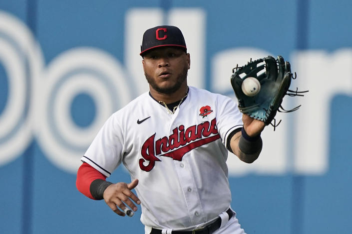 Cleveland Indians' Harold Ramirez fields a ball hit by Chicago White Sox's Nick Madrigal in the third inning of the second baseball game of a doubleheader, Monday, May 31, 2021, in Cleveland. Madrigal was safe at first base for a single. (AP Photo/Tony Dejak)