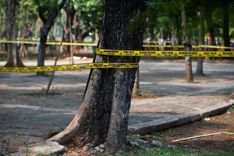 Police tape cordon off an area following a blast at National Monument (Monas) complex in Jakarta