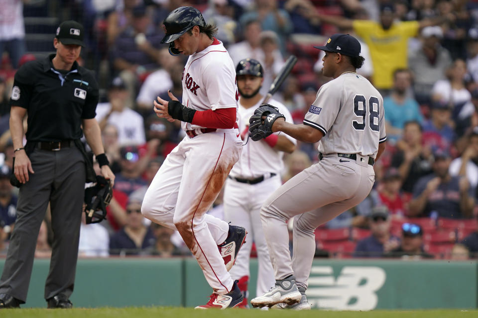 Boston Red Sox's Triston Casas, left, scores on a wild pitch as New York Yankees pitcher Randy Vasquez, right, is unable to tag him in the fourth inning in the first baseball game of a doubleheader, Tuesday, Sept. 12, 2023, in Boston. (AP Photo/Steven Senne)