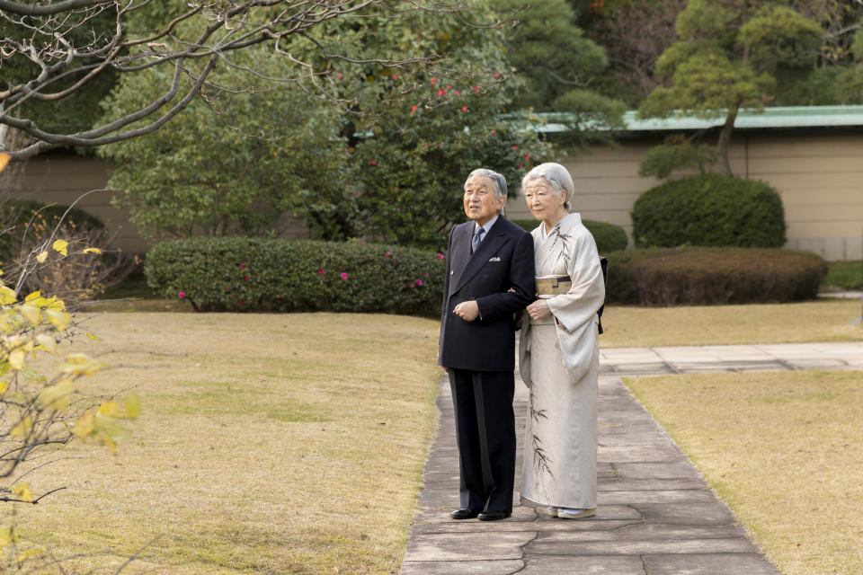 In this Monday, Dec. 10, 2018, photo released on Friday, Dec. 21, 2018, by the Imperial Household Agency of Japan, Japan's Emperor Akihito, left, and Empress Michiko, right, take a stroll at the garden of the Imperial Palace in Tokyo. Emperor Akihito, who turns 85 on Sunday, Dec. 23, and will abdicate this spring, says he feels relieved to see the era of his reign coming to an end without having seen his country at war. (The Imperial Household Agency of Japan via AP)