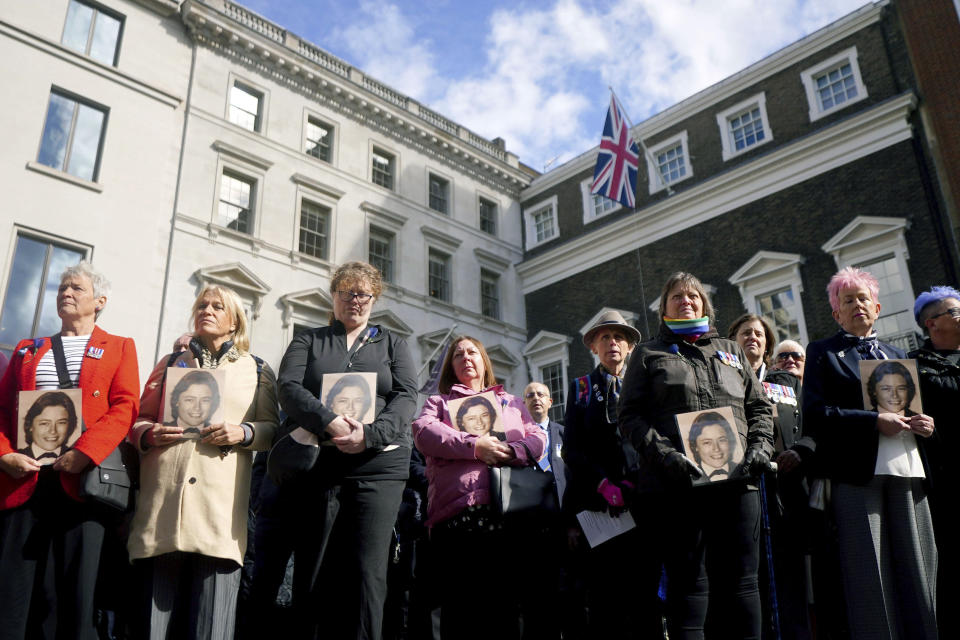 Colleagues of police constable Yvonne Fletcher hold photos of her as they gather in St James's Square for a 40th anniversary memorial service, in London, Wednesday, April 17, 2024. Hundreds of people attended a vigil in central London to commemorate the life of a police officer who was shot dead 40 years ago from inside the Libyan embassy. Constable Yvonne Fletcher, 25, was killed when men armed with submachine guns fired from the embassy’s windows, while she was policing a demonstration outside the building against the regime of then-Libyan leader Moammar Gadhafi. (Victoria Jones/PA via AP)