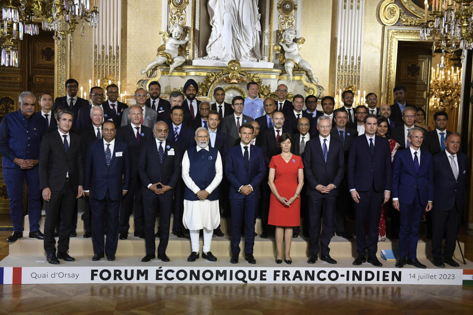 French President Emmanuel Macron and India's Prime Minister Narendra Modi, center left, pose with French Foreign Minister Catherine Colonna, fifth right, at the end of the Franco-Indian economic forum a meeting at the Foreign Affairs ministry in Paris, Friday, July 14, 2023. France is looking to further strengthen cooperation on an array of topics ranging from climate to military sales and the strategic Indo-Pacific region. (Julien de Rosa, Pool via AP)