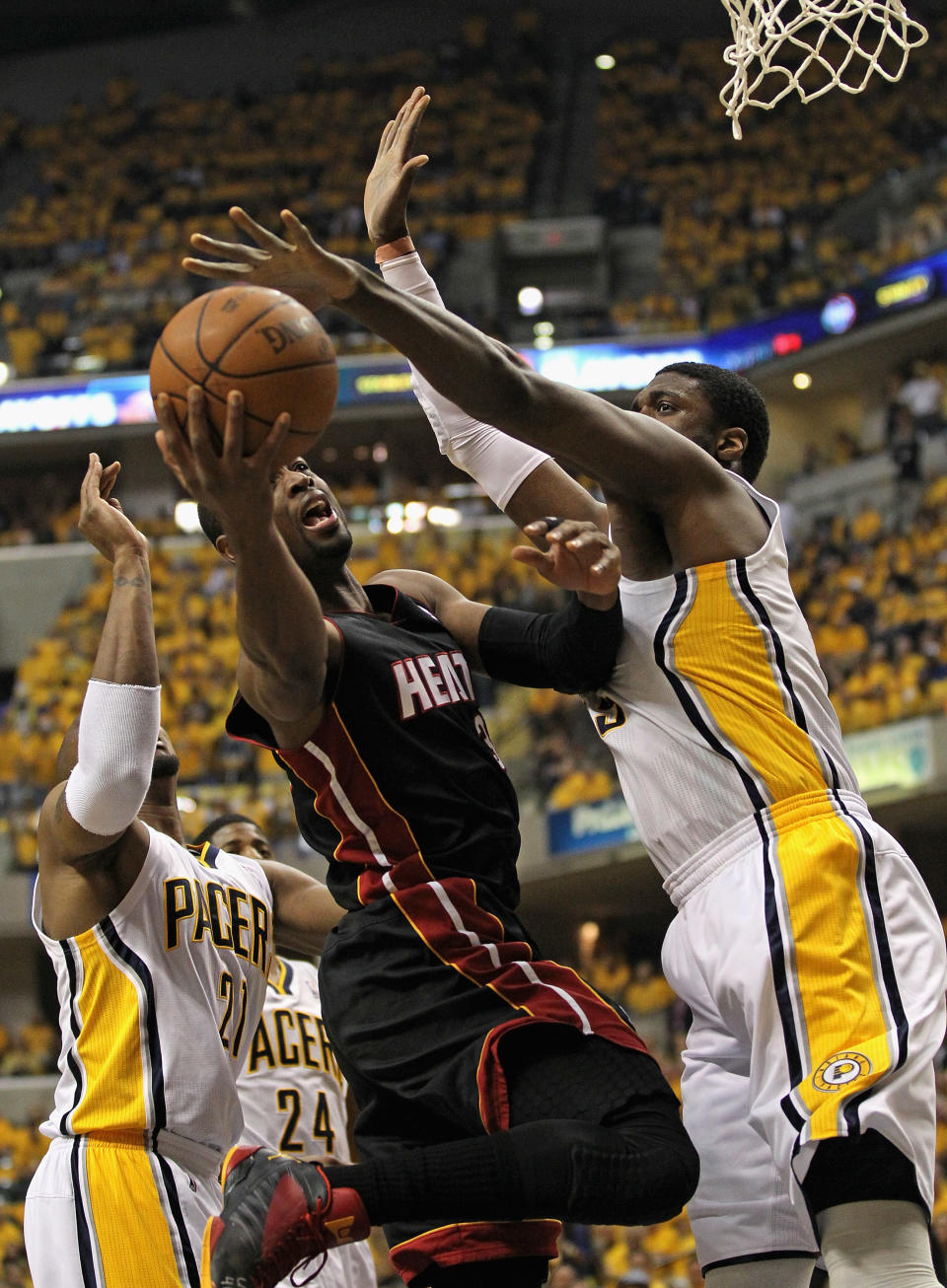 INDIANAPOLIS, IN - MAY 24: Dwyane Wade #3 of the Miami Heat shoots between David West #21 and Roy Hibbert #55 of the Indiana Pacers in Game Six of the Eastern Conference Semifinals in the 2012 NBA Playoffs at Bankers Life Fieldhouse on May 24, 2012 in Indianapolis, Indiana. NOTE TO USER: User expressly acknowledges and agrees that, by downloading and/or using this photograph, User is consenting to the terms and conditions of the Getty Images License Agreement. (Photo by Jonathan Daniel/Getty Images)