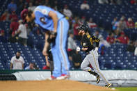 Pittsburgh Pirates' Colin Moran, right, rounds the bases past Philadelphia Phillies pitcher Aaron Nola after hitting a home run during the third inning of a baseball game, Thursday, Sept. 23, 2021, in Philadelphia. (AP Photo/Matt Slocum)