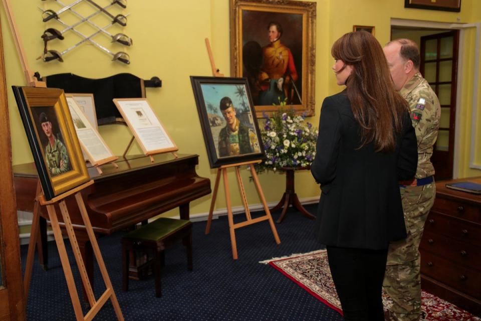 Princess of Wales looks at the pictures of the fallen soldiers of the Queen's Dragoon Guards Regiment (REUTERS)